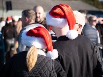 Two race goers in Christmas hats