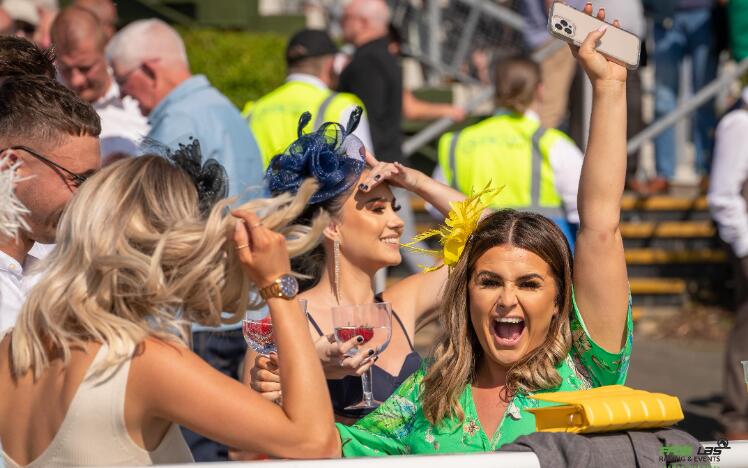 Ladies dressed for the races cheering and enjoying the sunshine at Ffos Las Races